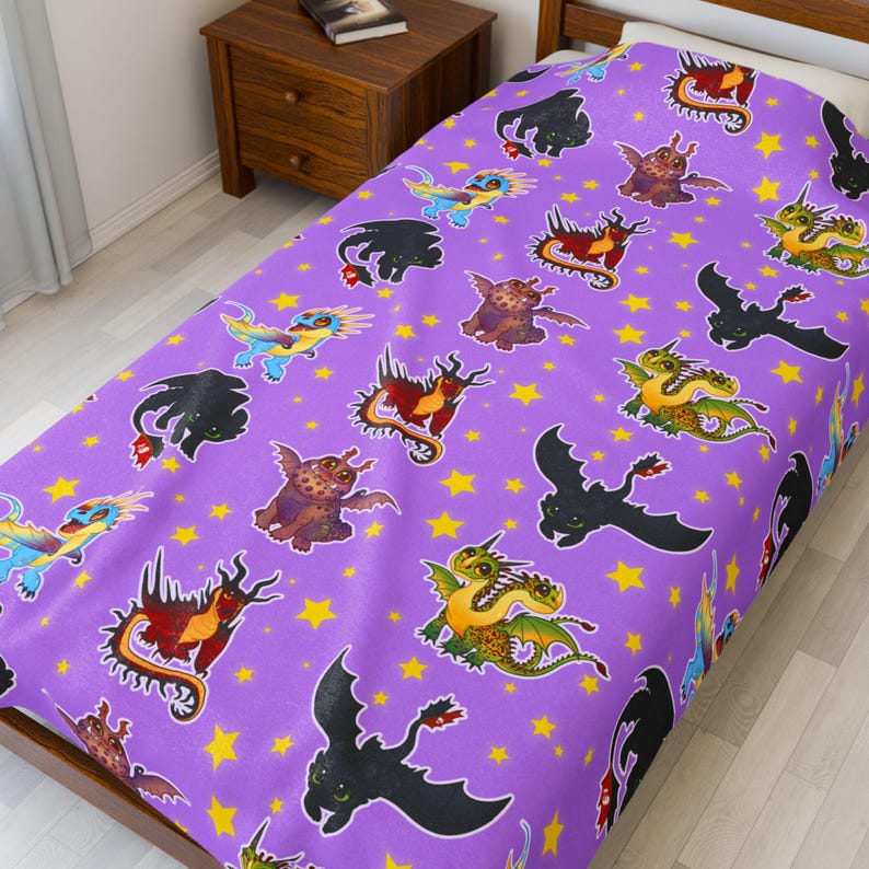 May include: A purple bedspread featuring a repeating pattern of cartoon dragons in various colors, including black, red, green, and blue. Yellow stars are scattered across the background. The bedspread is on a wooden bed frame.