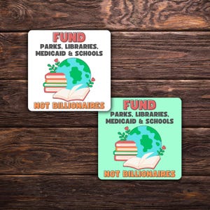 May include: Two square stickers with the text "FUND PARKS, LIBRARIES, MEDICAID & SCHOOLS NOT BILLIONAIRES". One sticker is white, the other is light green. Both feature a globe, books, and flowers.