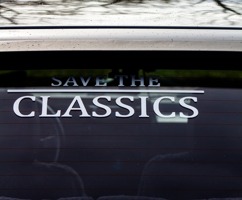 May include: A black car with a white sticker on the back window that says "Save the Classics".