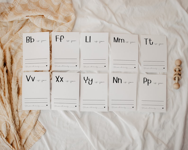 May include: Ten white cards with black lettering. Each card features a letter of the alphabet and the phrase "is for". The cards are arranged in two rows of five.