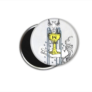 May include: A white and blue round magnet with a yellow chalice, a dove, and the letter 'W' in the center. The chalice is surrounded by blue lines and water droplets.
