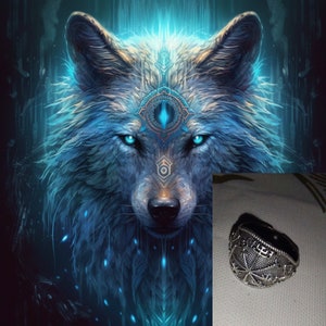 May include: A silver ring with a detailed design featuring a starburst pattern. The ring is set against a dark background.