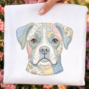 May include: White square pillow featuring a patchwork design of a dog's face. The dog's face is composed of various pastel-colored fabric patches, including floral, polka dot, and gingham patterns. The dog has brown eyes and a white snout.