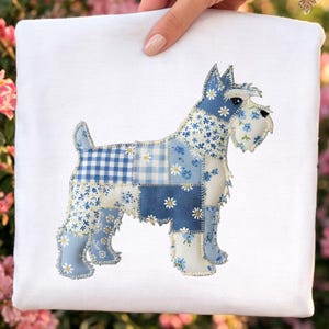 May include: A white square fabric with a patchwork design of a Schnauzer dog. The dog is made of various blue and white floral and gingham patterned fabrics. The dog's features are detailed with stitching.