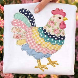 May include: A colorful rooster applique on a white background. The rooster features a patchwork design with various patterns, including polka dots, gingham, and floral prints. The rooster's comb and wattle are pink, and its legs are gold.