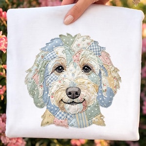 May include: A white square fabric with a detailed applique of a smiling dog's face. The dog's fur is made of patchwork fabric in pastel colors and floral patterns. The dog has dark eyes and a black nose.