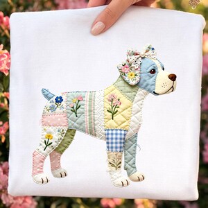 May include: A white square pillow featuring a patchwork dog design. The dog is composed of various fabric patterns, including floral prints, polka dots, and gingham. The dog's head is light blue with a floral bow, and the body is adorned with embroidered flowers.