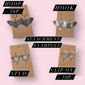 May include: Four cards with different earring attachment styles: hoop, hook, stud, and clip-on. Each card features a pair of earrings with a moth design. The cards have the text "ATTACHMENT EXAMPLES" and the names of each attachment style. The hoop and clip-on styles have the text "+50p" on their cards.