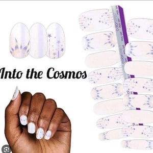 May include: A set of nail wraps with a space-themed design. The wraps feature a white background with blue and purple stars, a galaxy-like swirl, and the text "Into the Cosmos".