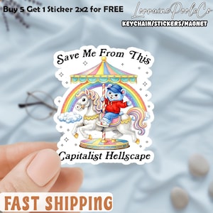 May include: A sticker featuring a cartoon bear riding a carousel horse under a rainbow. The text "Save Me From This Capitalist Hellscape" is displayed. The sticker also includes the text "Buy 5 Get 1 Sticker 2x2 for FREE" and "Lorraine Poole Co KEYCHAIN/STICKERS/MAGNET".