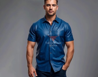 May include: A blue leather short-sleeved shirt with a button-down collar and a single pocket on the left chest. The shirt has a  "TailorMade Hides" logo on the pocket.