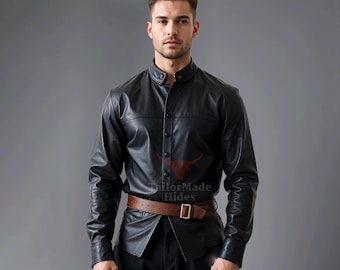 May include: A black leather long-sleeve shirt with a button-up collar and a brown leather belt. The shirt has a tailored fit and a classic design.