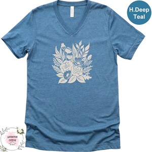 A blue t-shirt with a white floral design printed on it.