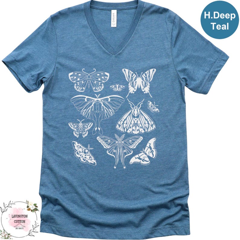 A blue t-shirt with a graphic design of various butterflies printed on it.