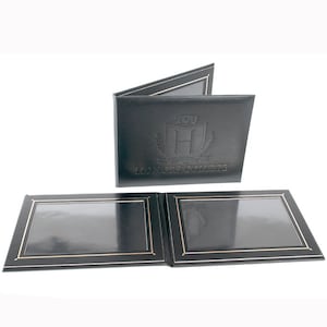 May include: Black diploma cover with gold trim and the text "TCU Honors College". The cover is open, revealing two clear display windows. The TCU logo is embossed on the front.