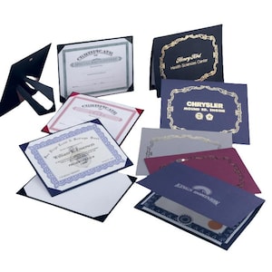 May include: Assorted certificate holders in various colors, including black, blue, and red. Some holders display certificates with text, while others are blank. The certificates feature gold foil accents and text such as "Certificate" and company names.