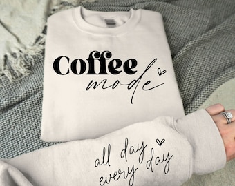 May include: A cream colored sweatshirt with the text "Coffee mode" and a heart on the front and the text "all day every day" and a heart on the sleeve.