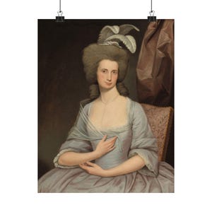 May include: A portrait painting of a woman in a light blue dress with a white lace collar. She is wearing a white feathered hat and has her hair styled in a powdered wig. The painting has a dark background.