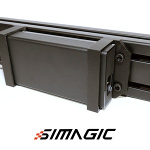 May include: A black power supply unit mounted to a black aluminum extrusion rail with two screws. The power supply has a black cable attached to it.