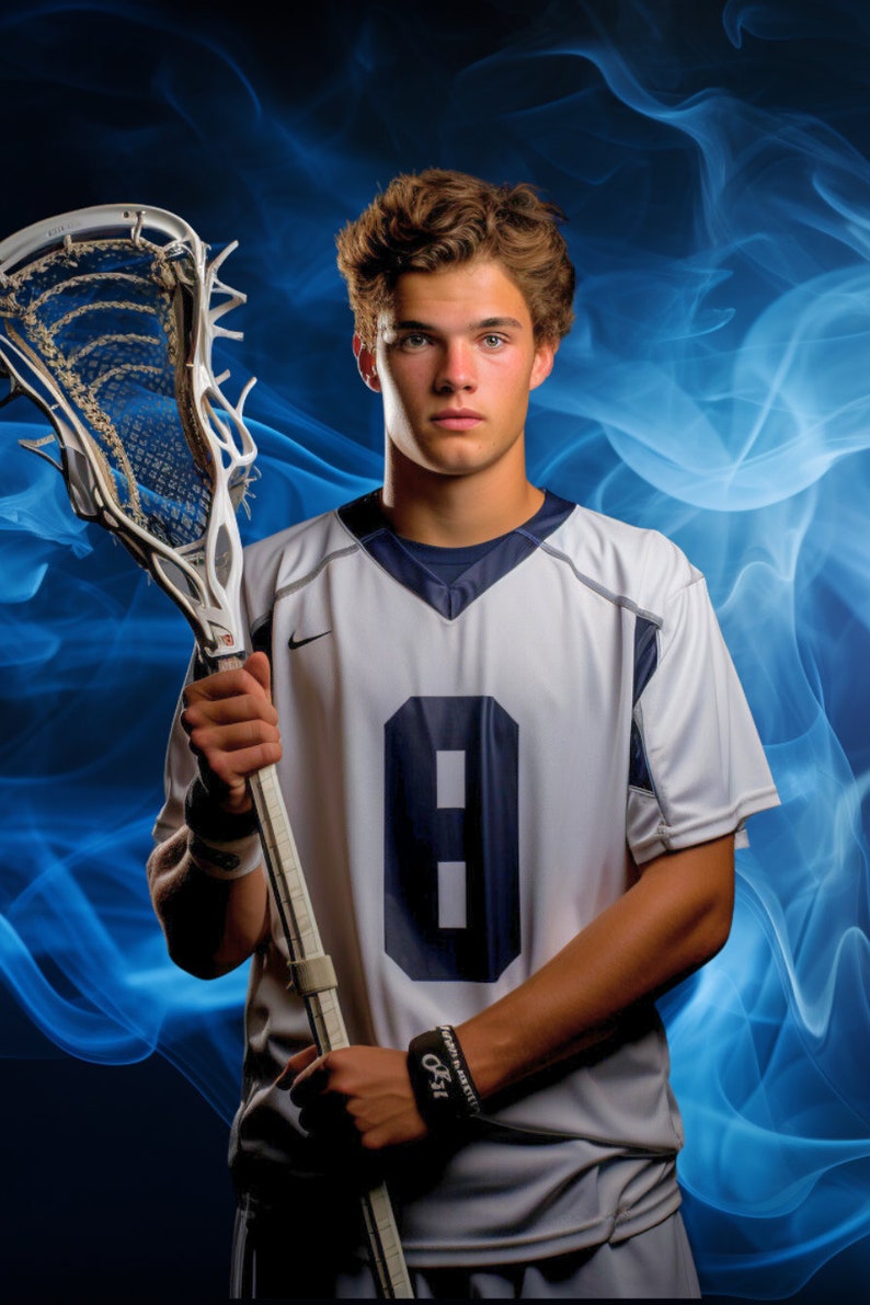 May include: A young man wearing a white lacrosse jersey with a blue number 8 on the front. He is holding a lacrosse stick in his right hand. The background is a blue and white smoke effect.
