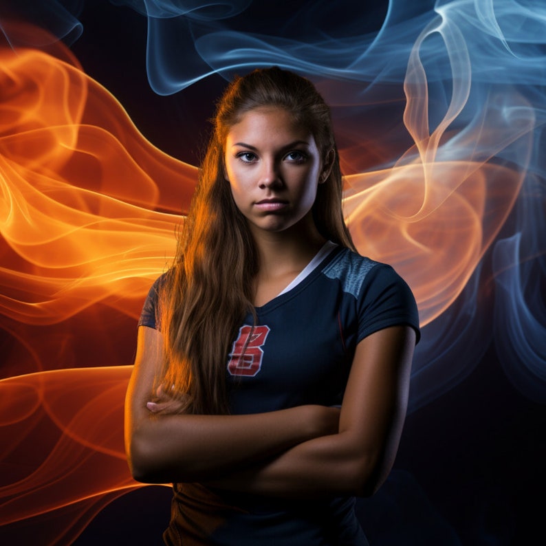 May include: A young woman with long brown hair is wearing a dark blue jersey with a red and white letter "B" on the front. She is standing in front of a background of orange and blue smoke.