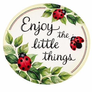 May include: Round decorative sign with the phrase "Enjoy the little things" in black script. The sign features red ladybugs with black spots and green leaves against a cream background, framed by red and black lines.