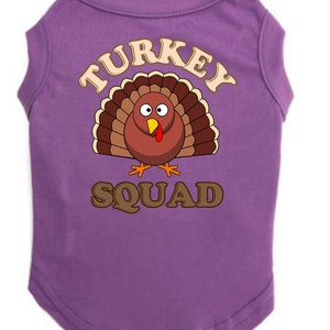 May include: Purple dog shirt with a cartoon turkey and the text "TURKEY SQUAD".