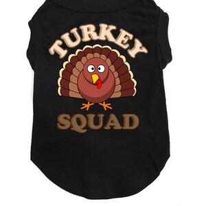 May include: Black dog shirt with a brown turkey graphic and the text "TURKEY SQUAD".