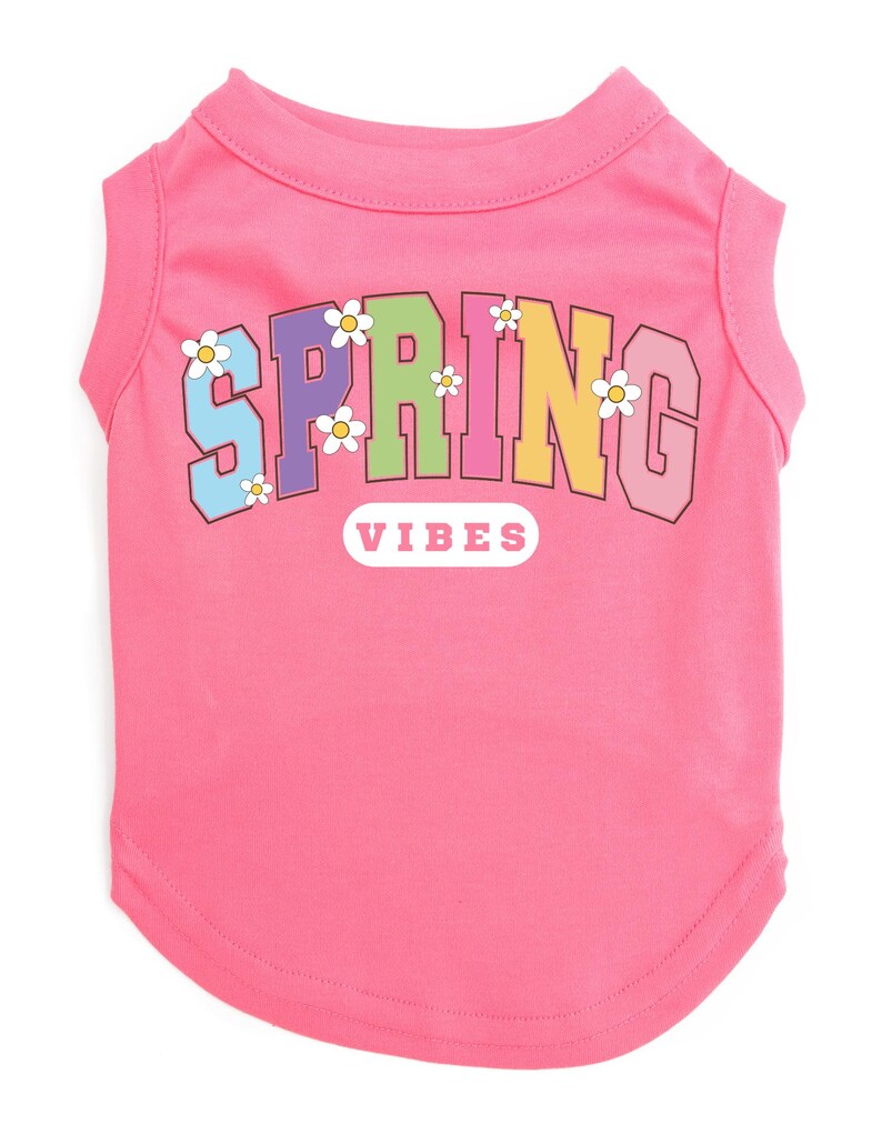 May include: Pink sleeveless dog shirt with a rainbow colored "SPRING VIBES" graphic with white daisies.
