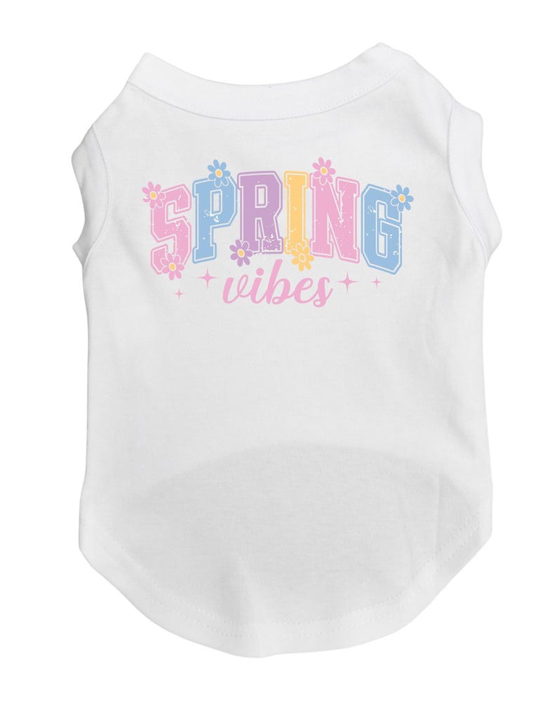 May include: White dog shirt with a colorful "SPRING vibes" graphic with flowers.