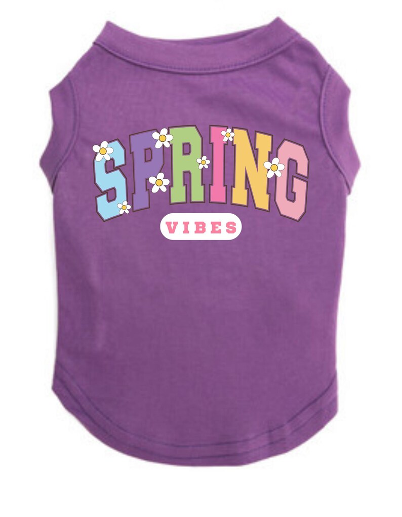 May include: Purple sleeveless dog shirt with the text "SPRING" in rainbow colors and white flowers. The text "VIBES" is below the word "SPRING" in a pink rectangle.
