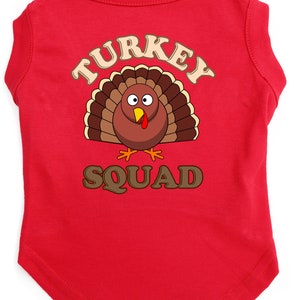 May include: Red dog t-shirt with a cartoon turkey graphic and the text "TURKEY SQUAD".
