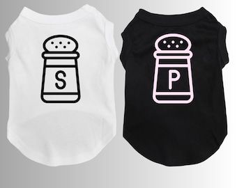 May include: Two dog shirts, one white and one black, with a salt and pepper shaker graphic. The white shirt has a black shaker with the letter "S" on it. The black shirt has a white shaker with the letter "P" on it.