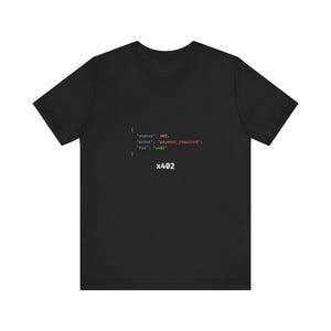 May include: A black short-sleeved t-shirt featuring a white code snippet printed on the chest. The text reads: { "status": 402, "error": "payment_required", "fix": "x402" } followed by the text x402 centered below the code block.