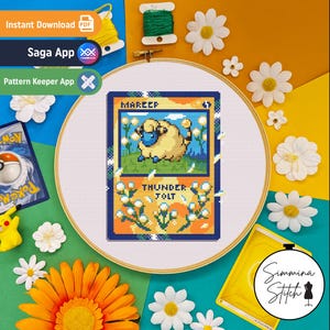 May include: A cross-stitch embroidery project in a wooden hoop featuring a pixelated Mareep character on a trading card design with the text Mareep and Thunder Jolt. The design includes a blue sky, green grass, and orange accents with white flowers.
