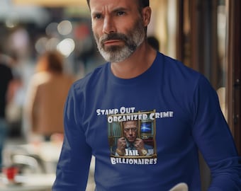 May include: A long-sleeve, navy blue shirt with the text "STAMP OUT ORGANIZED CRIME" and "JAIL BILLIONAIRES". The shirt features a graphic of a man behind bars. The person is holding a newspaper.