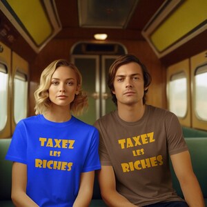 May include: Two people wearing t-shirts with the text "TAXEZ LES RICHES" in yellow letters on a blue and brown shirt.