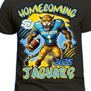May include: Black t-shirt featuring a fierce jaguar in a football uniform, holding a football. The design includes the words "Homecoming", "Southern", and "Jaguars", with the year "2025". The jaguar is in blue and gold.