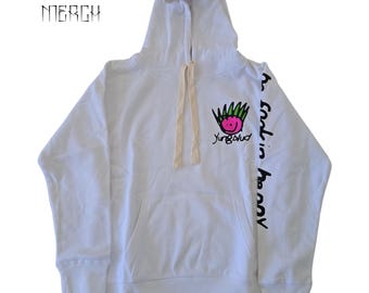 May include: White hooded sweatshirt with a pink and green cartoon face graphic and the text "Yungblud" on the front. The right sleeve has the text "the good in heavy" printed vertically.