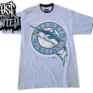 vintage 1990s Florida Marlins "Saturday's Hero" Graphic Shirt.