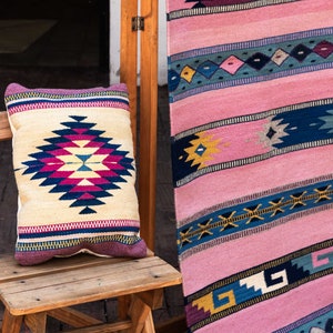 May include: A wooden chair with a colorful patterned pillow on the seat. The chair is in front of a pink and blue patterned rug.