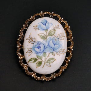 Vintage Porcelain Floral Brooch. Gold tone Openwork Setting, Pale Blue Roses Decal with Hand Painted Finish.
