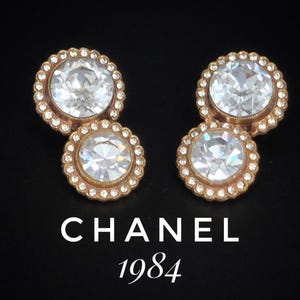 Boucles d'oreilles clip CHANEL authentiques de 1984, rares et rares en plaqué or avec de grandes pierres de cristal. Signé CHANEL 1984.