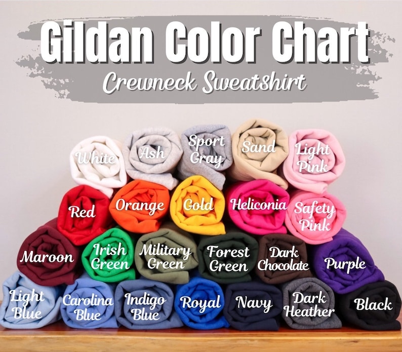 May include: A Gildan crewneck sweatshirt colour chart, displaying rolled fabric samples in various shades. Colours include white, ash, sport grey, sand, light pink, red, orange, gold, and others. The text "Gildan Color Chart Crewneck Sweatshirt" is at the top.