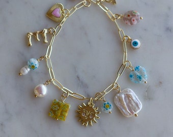 Swim the Sea Charm Bracelet: pink heart charm, baroque pearl, millefiori beads, letter initial charm, sun charm, evil eye, zodiac charm