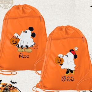 May include: Two orange drawstring bags with Halloween-themed designs. Each bag features a cartoon mouse dressed as a ghost, holding a jack-o'-lantern. One bag has the name "Aldo" and the other "Olivia" printed on it.