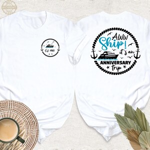 May include: White t-shirt with a black and white graphic of a ship with the text "Aww Ship! It's an Anniversary Trip" on the back. The front of the shirt has a small black and white graphic of a ship with the text "Est. 1985".