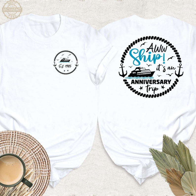 May include: White t-shirt with a black and white graphic of a ship with the text "Aww Ship! It's an Anniversary Trip" on the back. The front of the shirt has a small black and white graphic of a ship with the text "Est. 1985".
