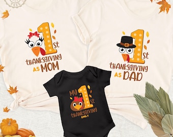 May include: Two cream-coloured t-shirts and one black baby bodysuit. The shirts feature a turkey graphic, the number 1, and text reading 1st Thanksgiving as Mom or Dad. The bodysuit features a turkey, the number 1, and My 1st Thanksgiving Emily.