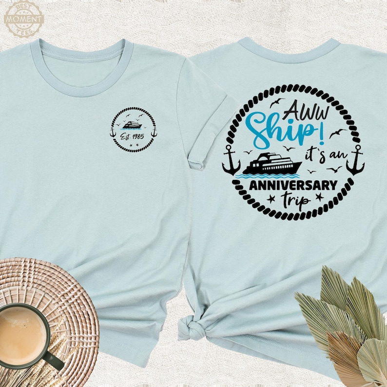 May include: Two light blue t-shirts with a nautical theme. One shirt has a ship and the text "Aww Ship! It's an Anniversary Trip". The other shirt has a small ship and the text "Est. 1985".